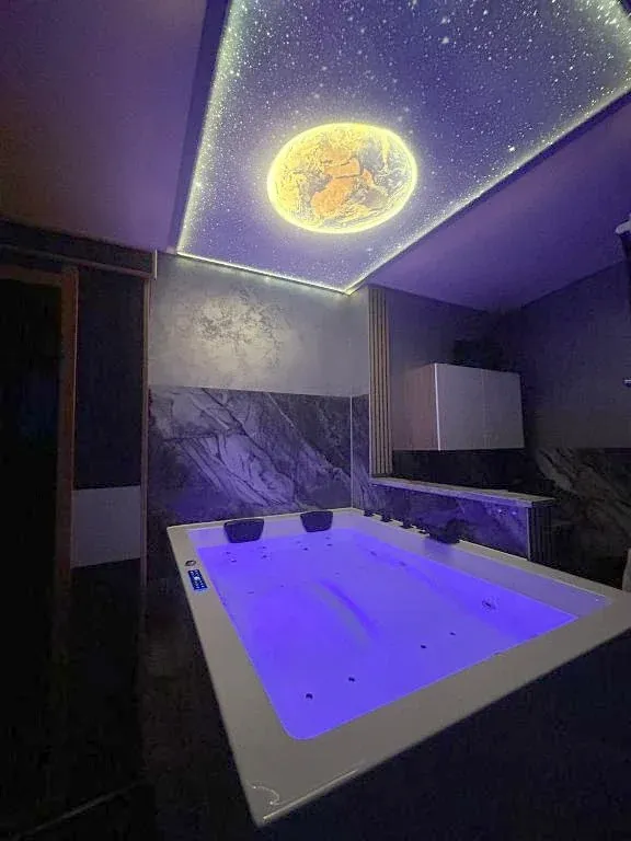 Beleuchteter Whirlpool unter der Sternenhimmel-Decke